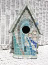 Gray bird house with waves crashiing on front mosaic